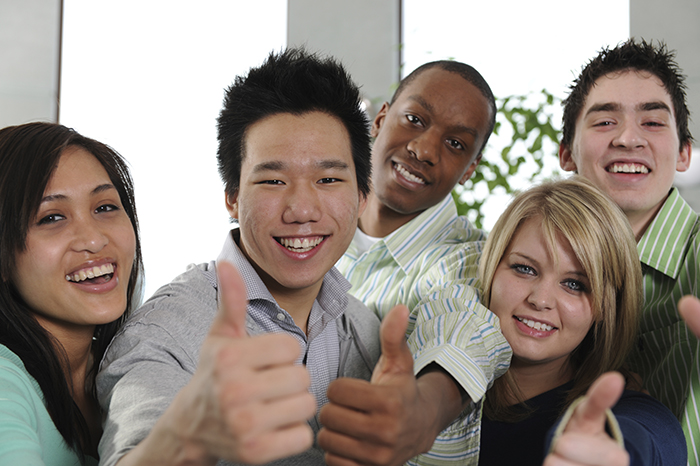 Multi ethnic college students on campus together